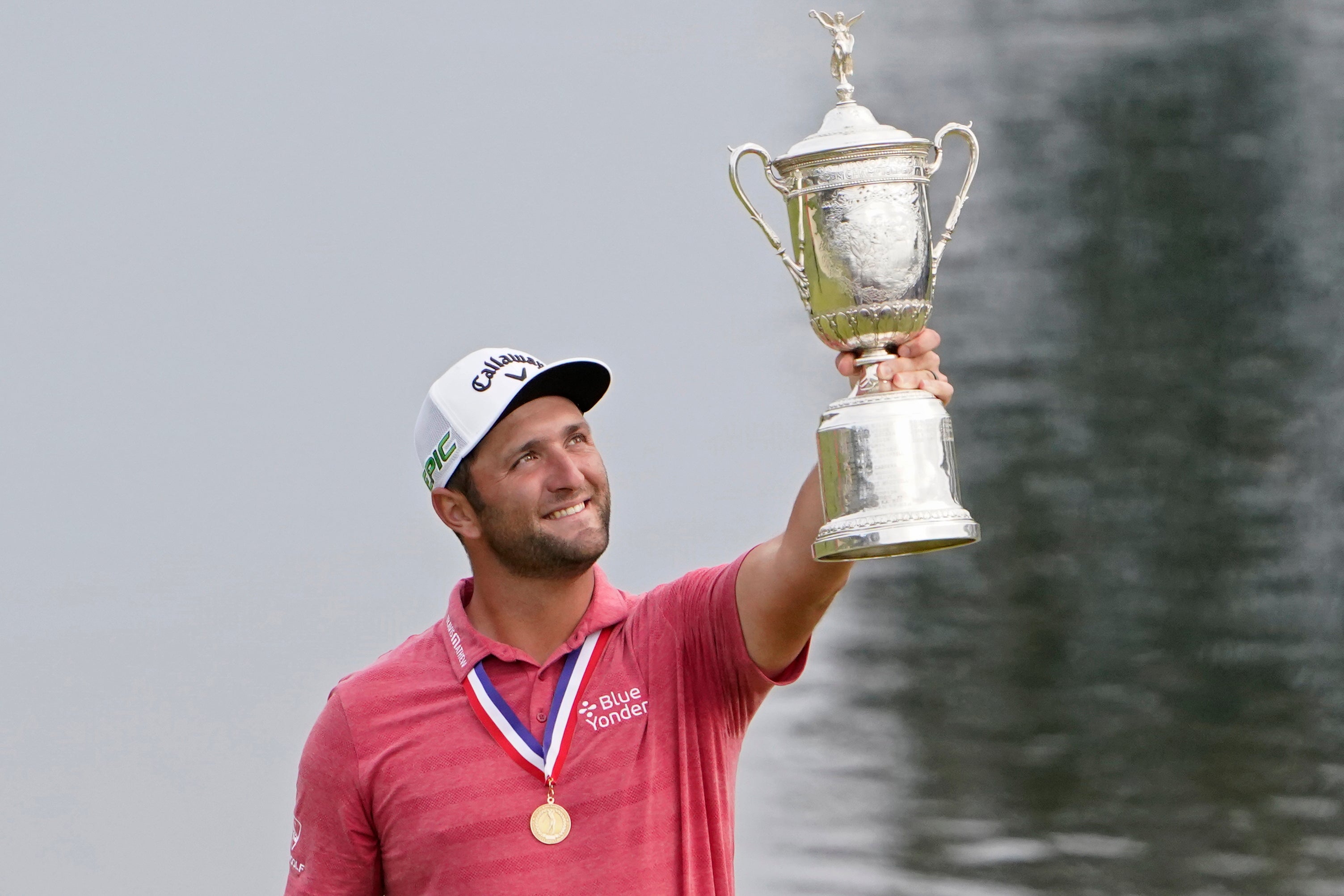 Jon Rahm, of Spain, holds the US Open champions trophy