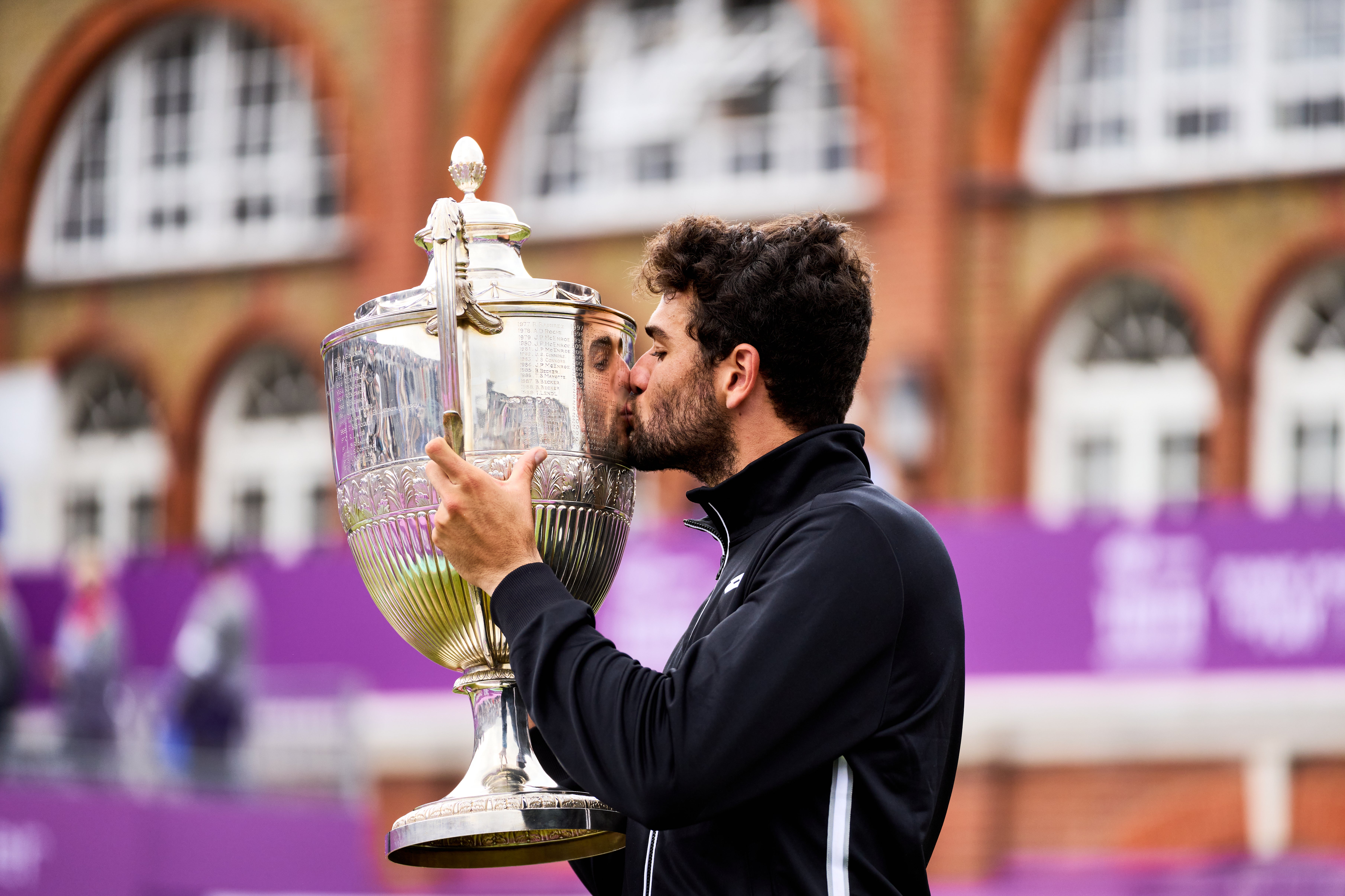 Matteo Berrettini kisses the trophy after winning the cinch Championships, defeating Great Britain's Cameron Norrie