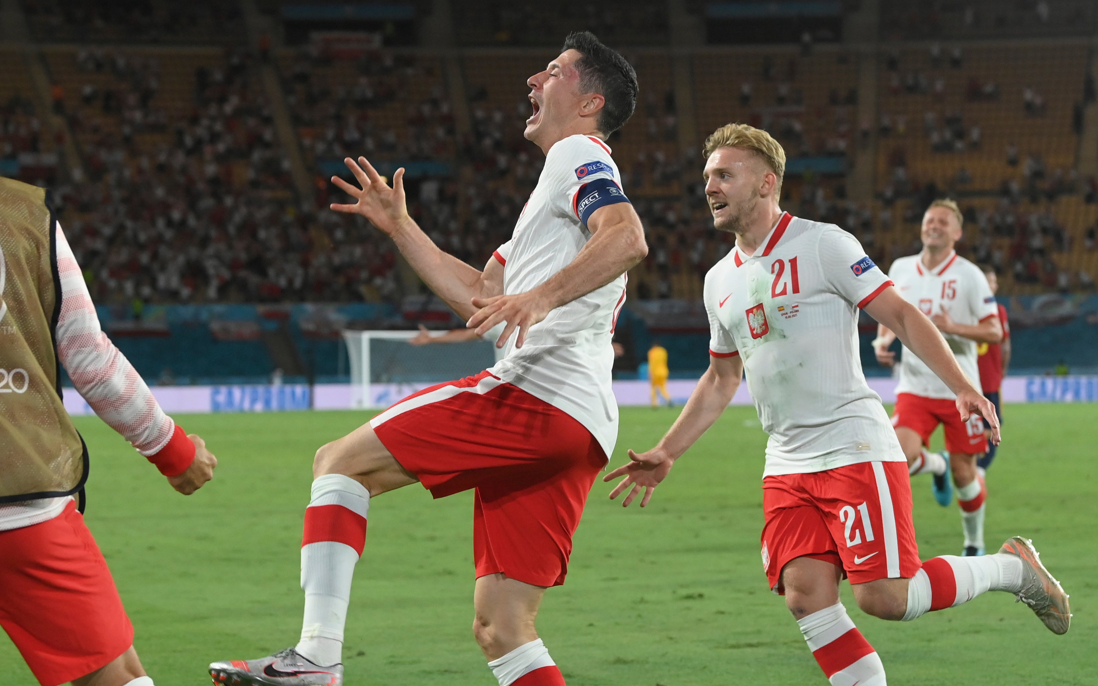 Robert Lewandowski, centre, celebrates scoring the equaliser in Poland's 1-1 draw with Spain on Saturday