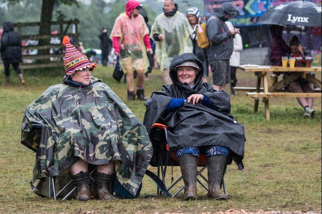 <p>Festival-goers brave the elements at Kendal Calling in 2019</p>