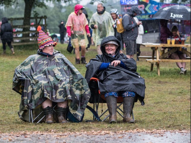 <p>Festival-goers brave the elements at Kendal Calling in 2019</p>