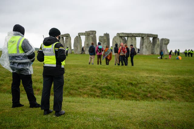 <p>Security guards monitoring Stonehenge as hundreds descend on the closed site for the summer solstice</p>