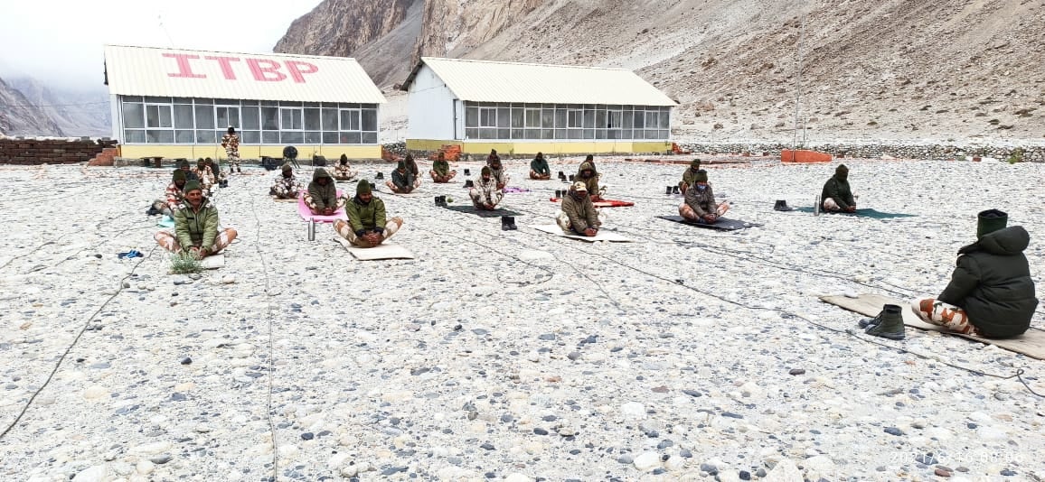 A handout photo made available by the Indo-Tibetan Border Police shows officers performing yoga at a height of about 15,000 feet in Ladakh on 21 June, 2021.