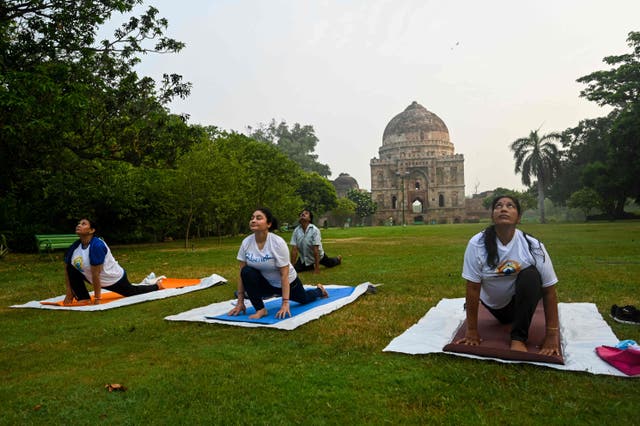 <p>People perform yoga in a park on International Yoga Day in New Delhi on 21 June, 2021</p>