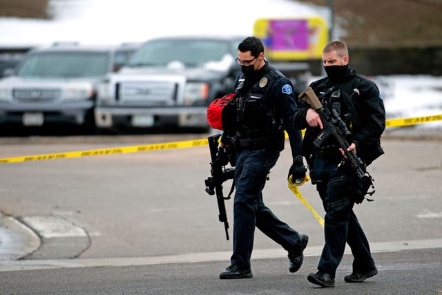 <p>Police officers walk through the parking lot of the King Soopers grocery store in Boulder, Colorado on 22 March, 2021 after reports of an active shooter. The shooting left 10 people dead.</p>