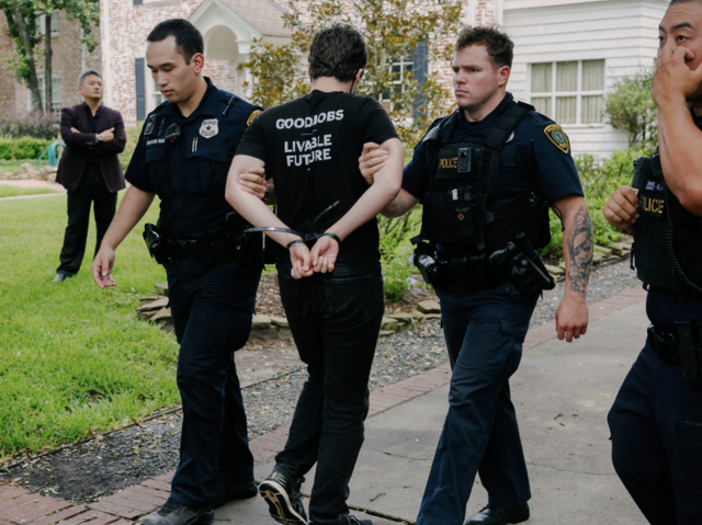 <p>Young people protesting the climate crisis at the home of Republican Senator Ted Cruz in Texas are led away by police on Monday</p>