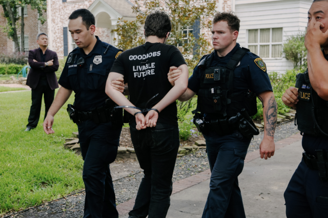 <p>Young people protesting the climate crisis at the home of Republican Senator Ted Cruz in Texas are led away by police on Monday</p>