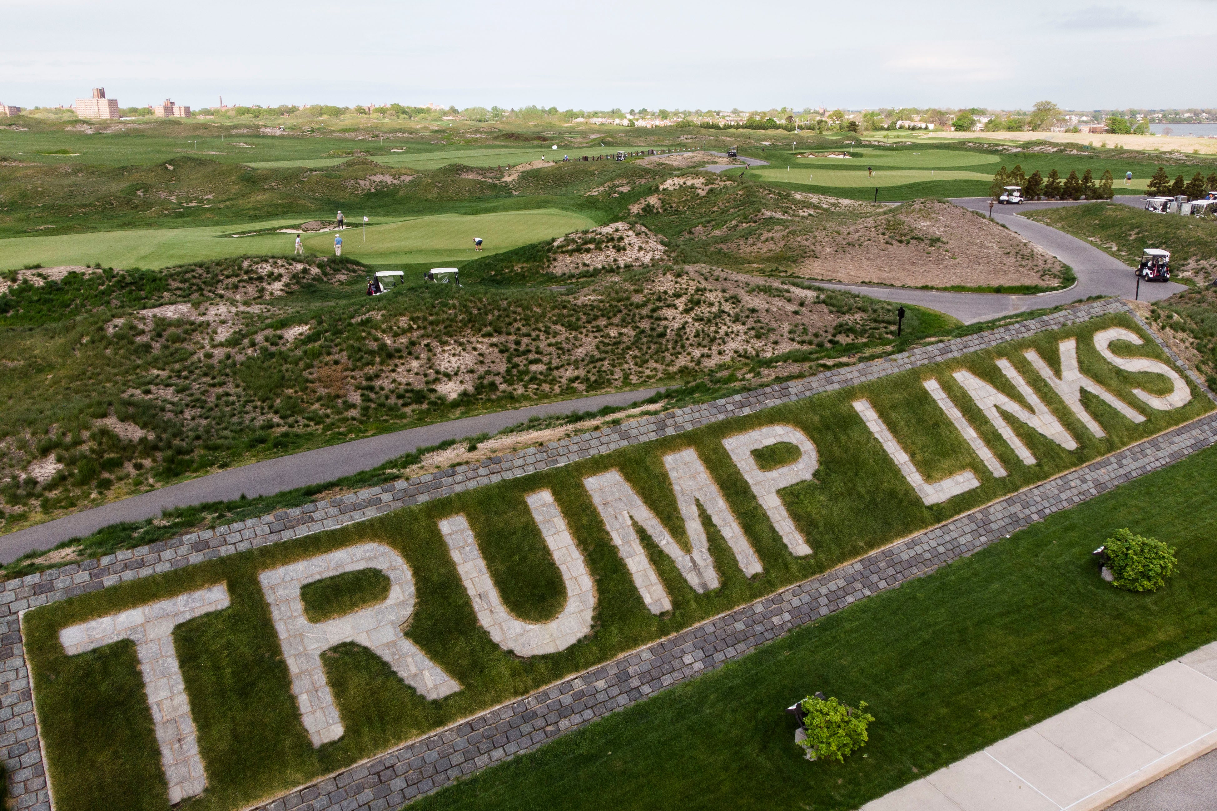 File image: Patrons play the links as a giant branding sign is displayed with flagstones at Trump Golf Links at Ferry Point in the Bronx borough of New York on Tuesday, 4 May, 2021