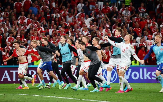 <p>Denmark players celebrate in front of their fans following their 2-1 win over Russia in Copenhagen on Monday. The victory sets up a round of 16 meeting with Wales</p>