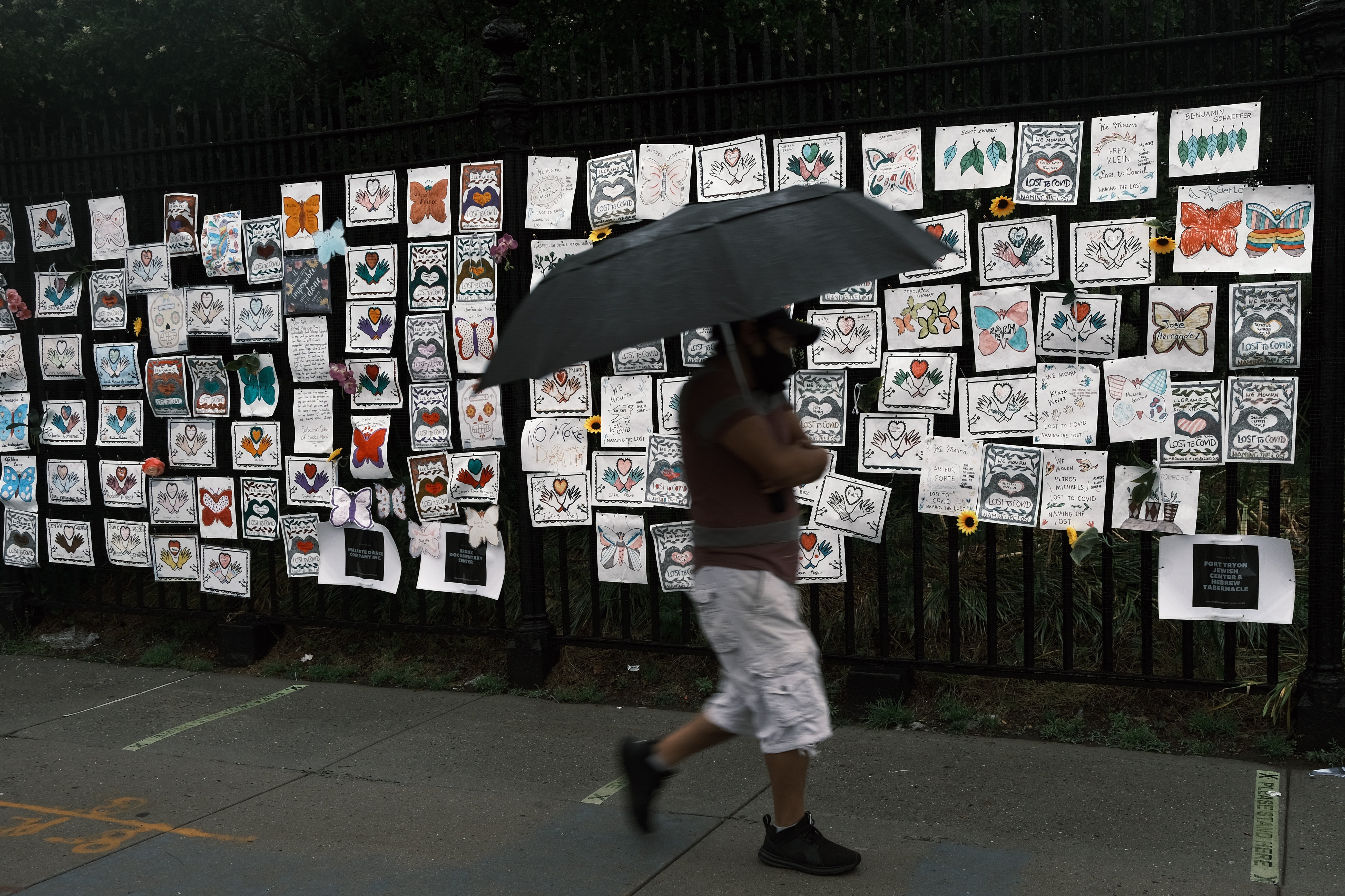 A man walks past a memorial in New York City to those who have died during the Covid-19 pandemic.