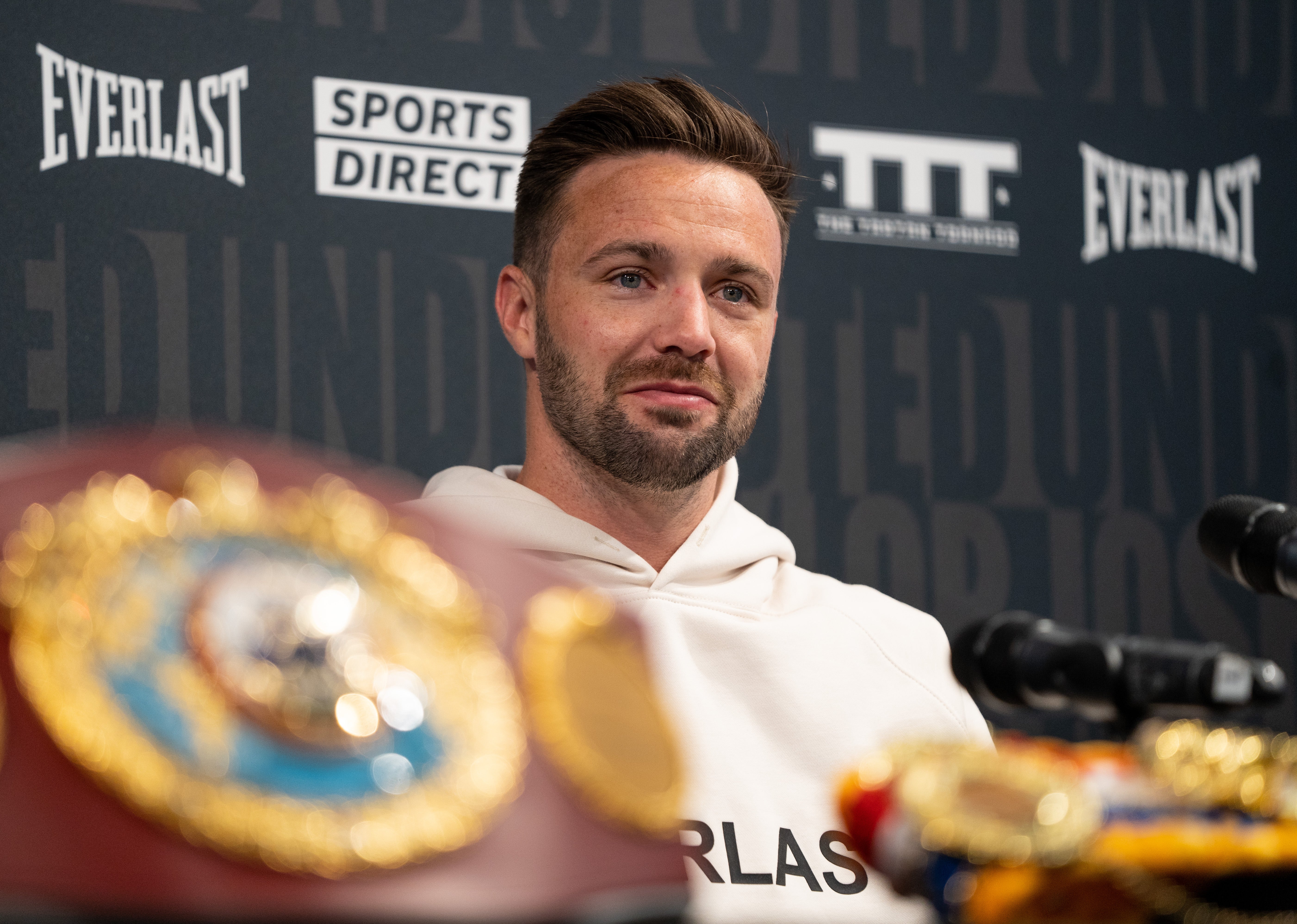 Josh Taylor poses with his collection of world titles after victory over Jose Ramirez