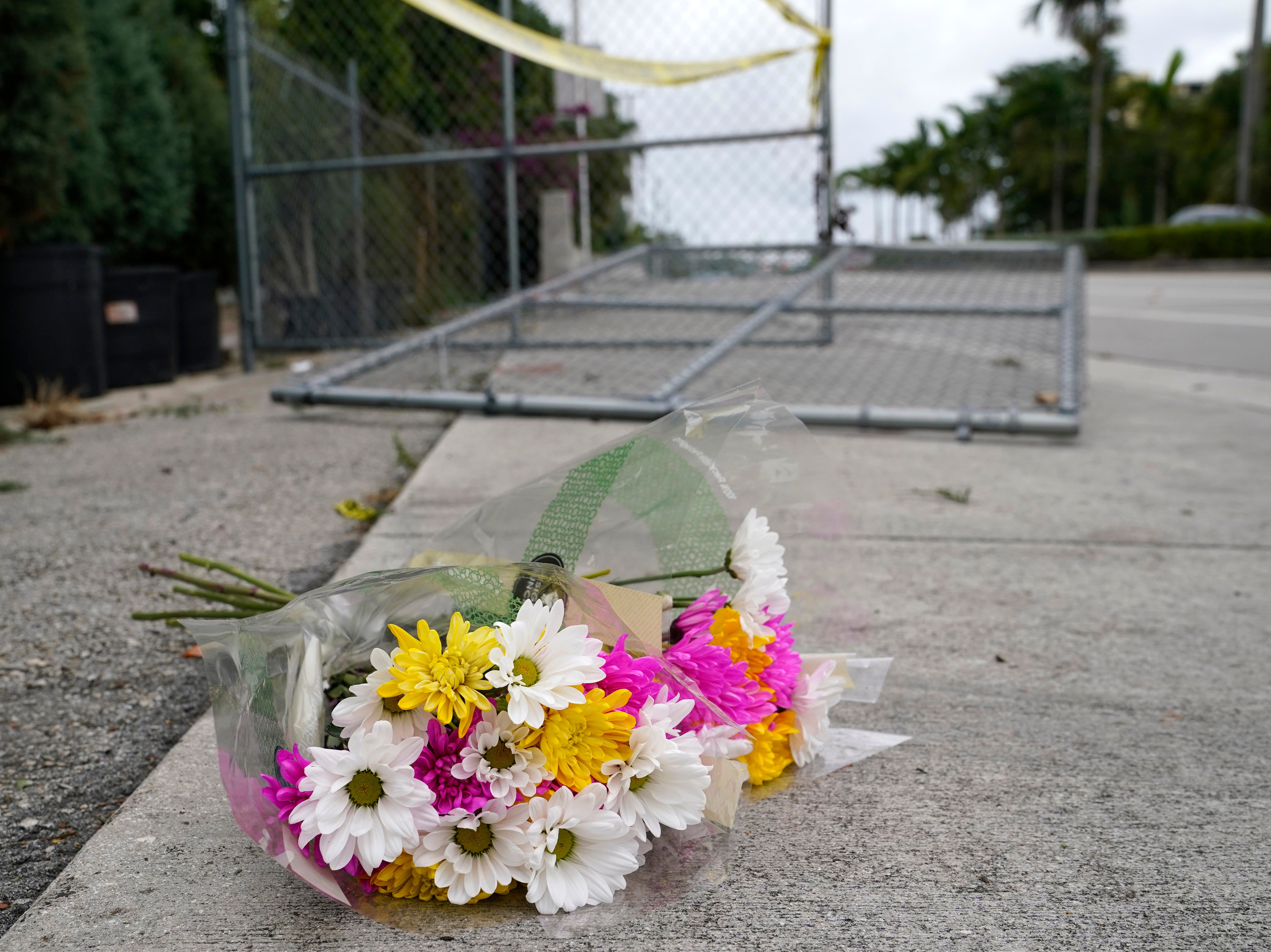 Flowers lie at the scene where a driver slammed into spectators at the start of a Pride parade Saturday evening, killing one man and seriously injuring another, Sunday 20 June 2021