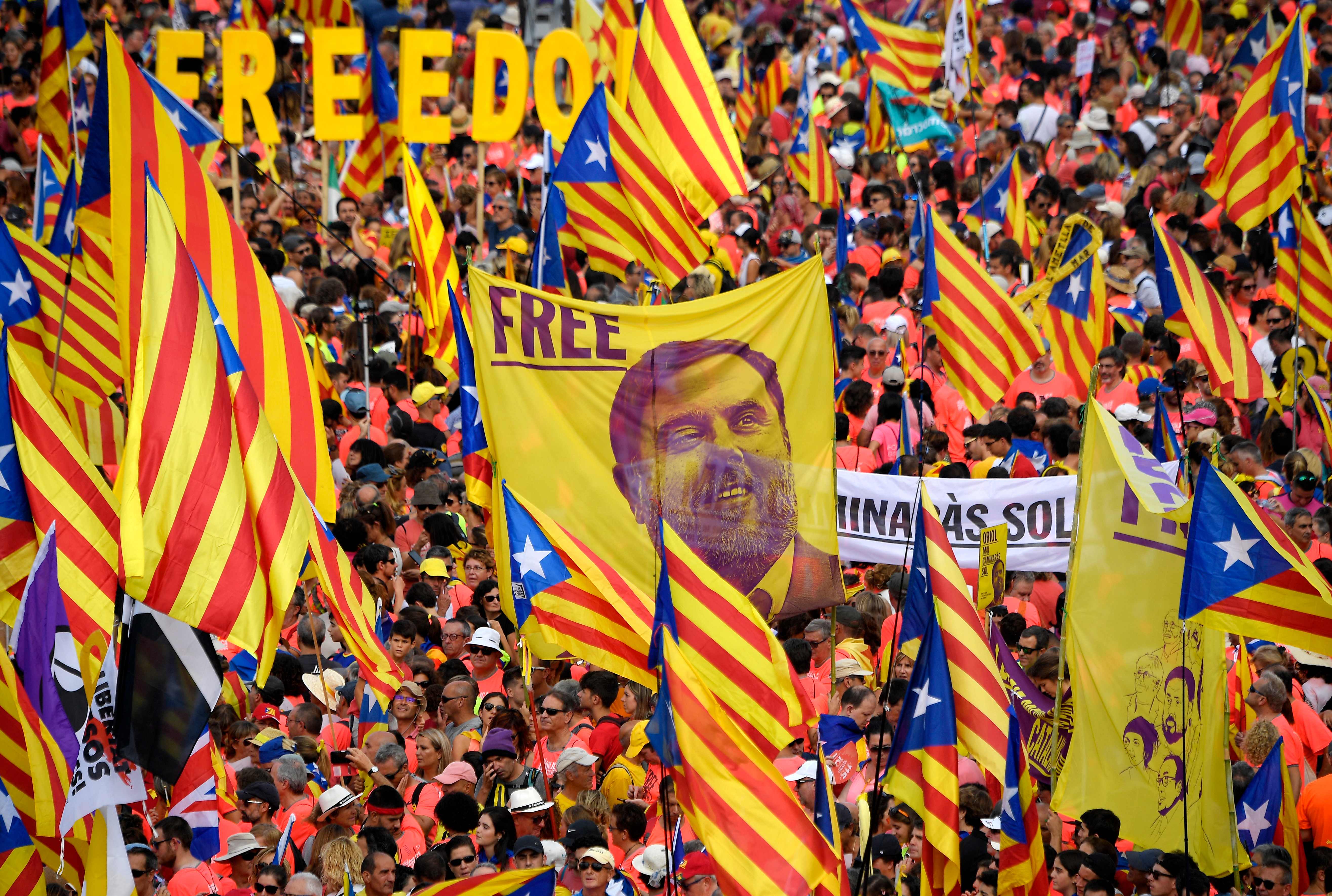 Demonstrators hold a banner demanding freedom for Catalan jailed leader Oriol Junqueras