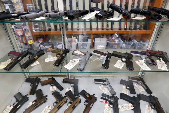 <p>In this March 25, 2020, file photo semi-automatic handguns are displayed at shop in New Castle, PA. </p>