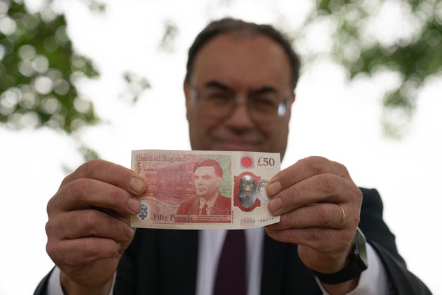 Andrew Bailey holds a new £50 note