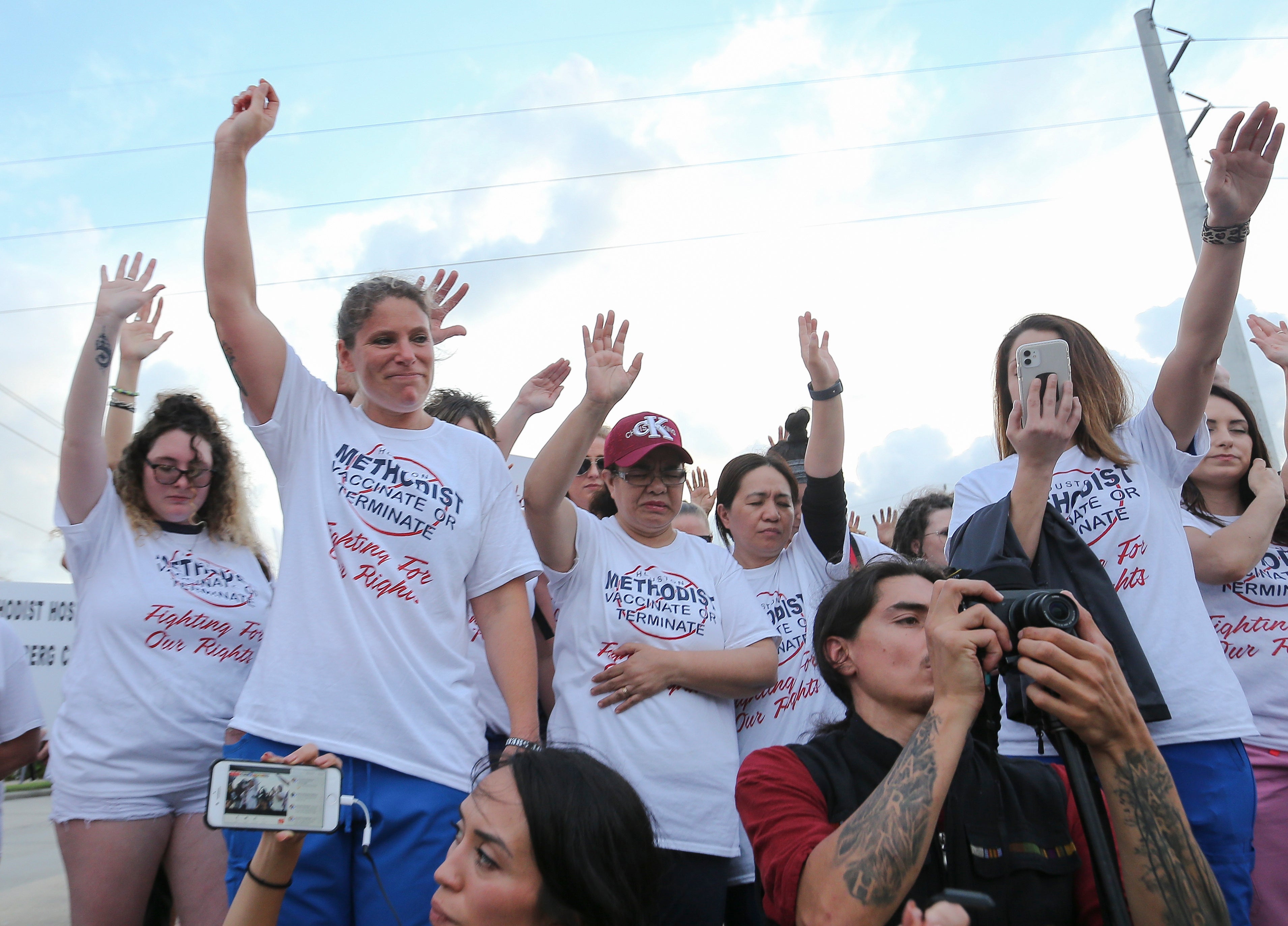 File image: In this 7 June, 2021, file photo, people gather to say a prayer in Baytown, Texas, while protesting against a Houston Methodist Hospital policy that says employees must get vaccinated against Covid-19 or lose their jobs
