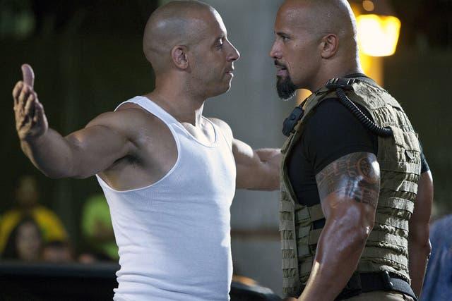 <p>Vin Diesel and Dwayne Johnson in ‘Fast Five'</p>