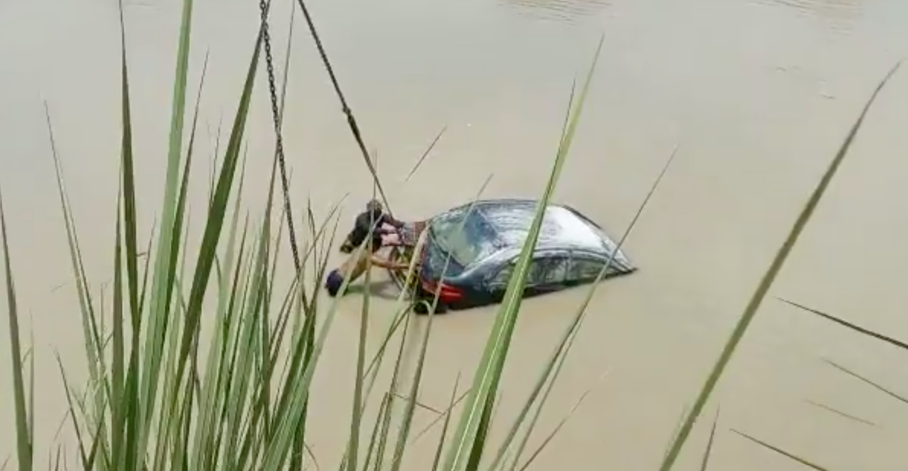 Screengrab from a video of a car being pulled out of the Ganges canal in India’s Uttar Pradesh state