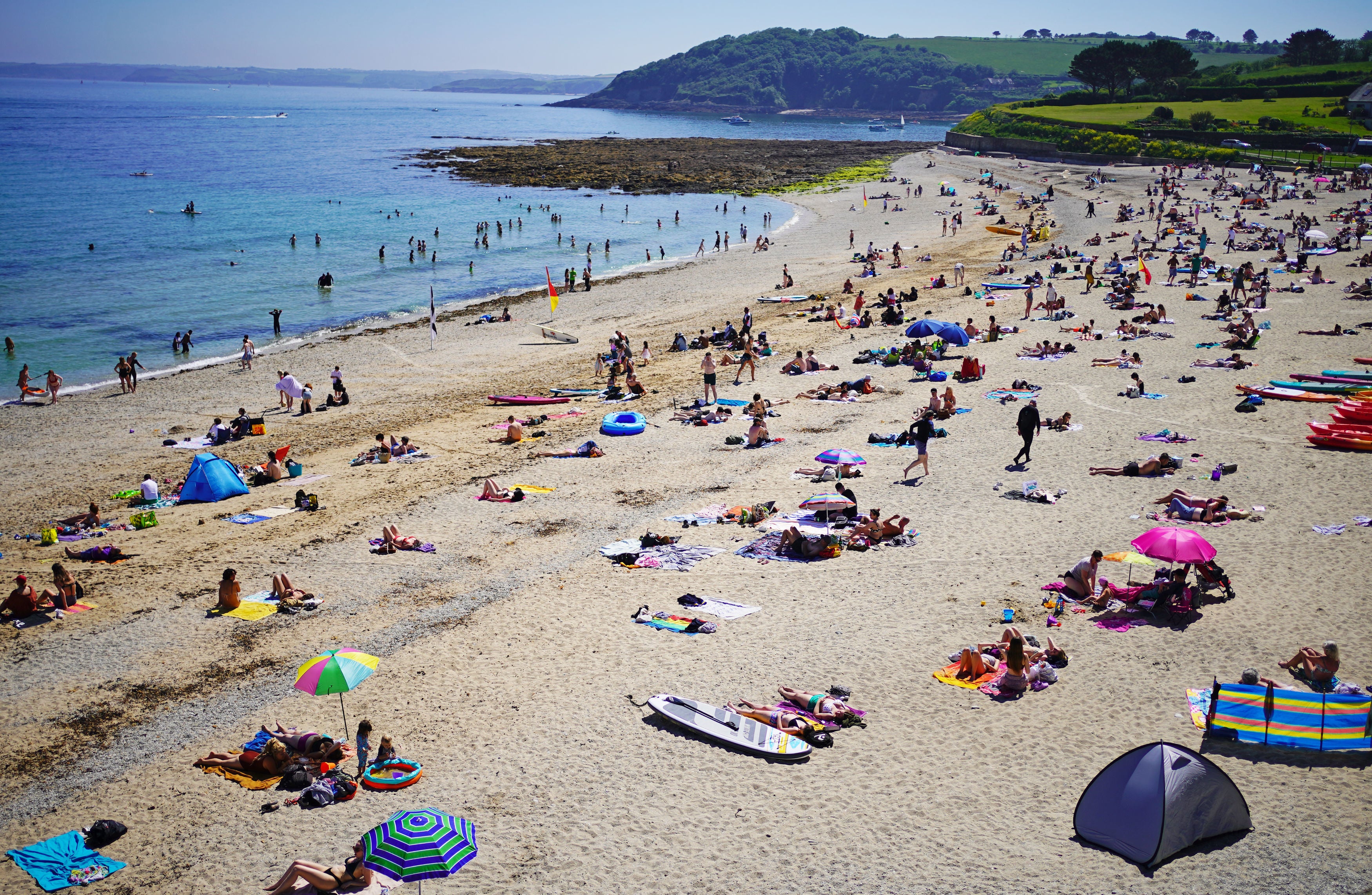People enjoy the sunshine on Gyllyngvase Beach at Falmouth in Cornwall