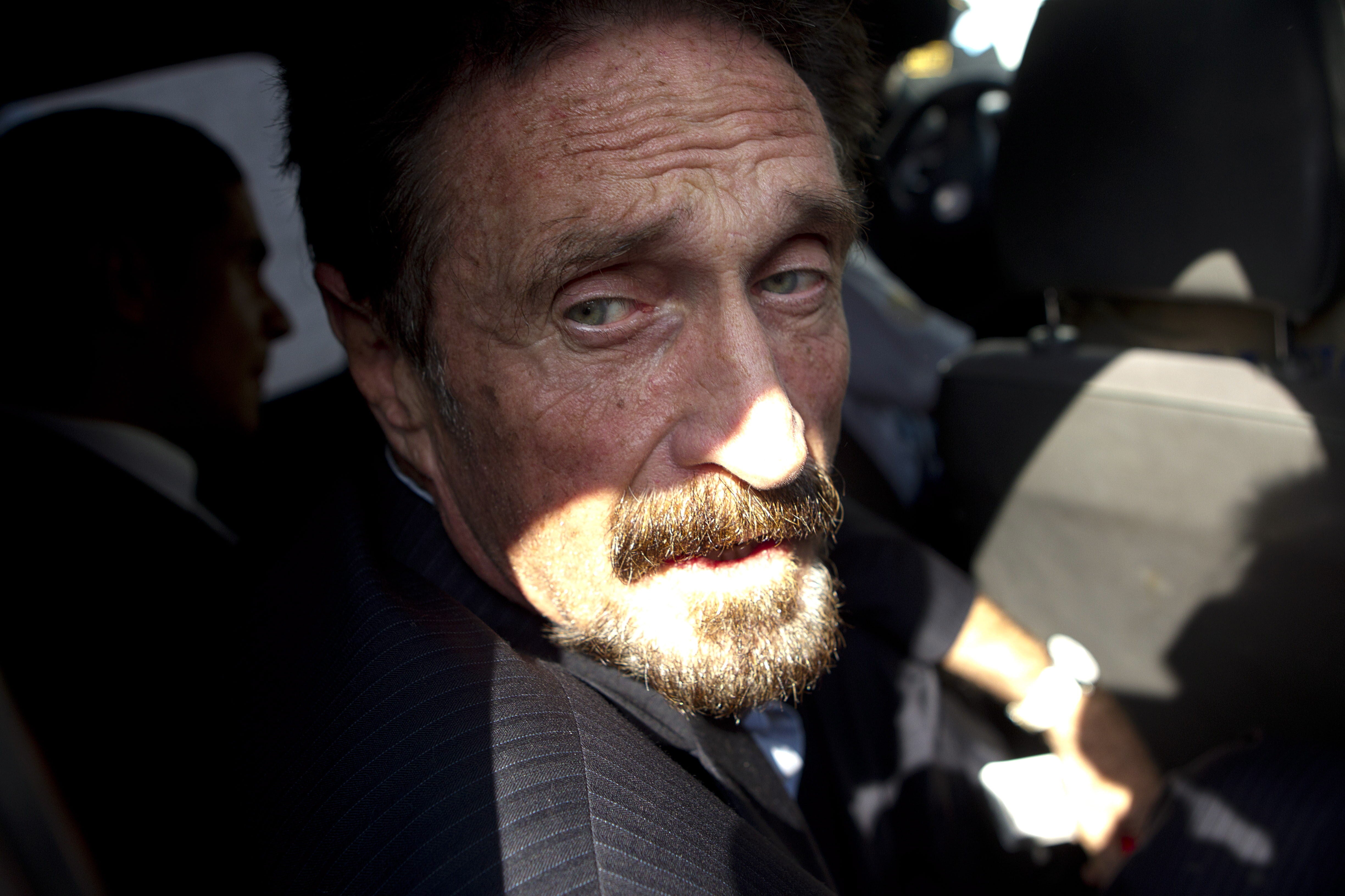 US millionaire John McAfee inside a vehicle of Guatemalan Migration towards airport in Guatemala City, Guatemala