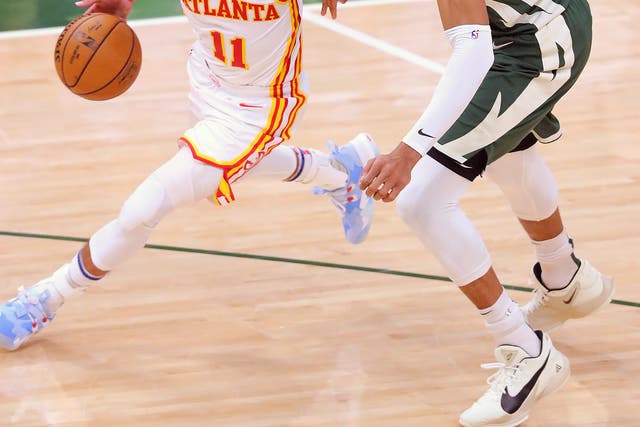 Trae Young, left, exploded with an enormous 48 points as his Atlanta Hawks claimed the first game of the Eastern Conference Finals 116-113 over the Milwaukee Bucks