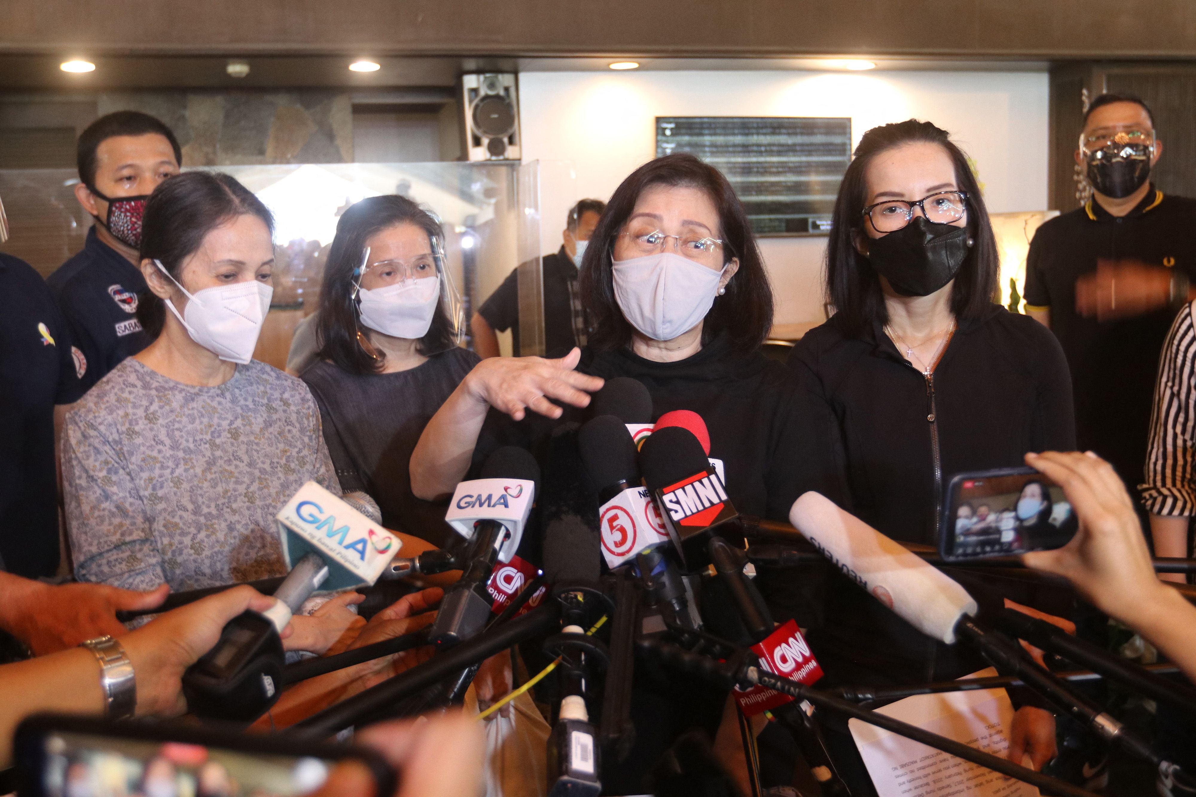 Pinky Aquino-Abellada (C) gestures after reading the family statement on the death of their brother former president Benigno Aquino, at a memorial park in Manila