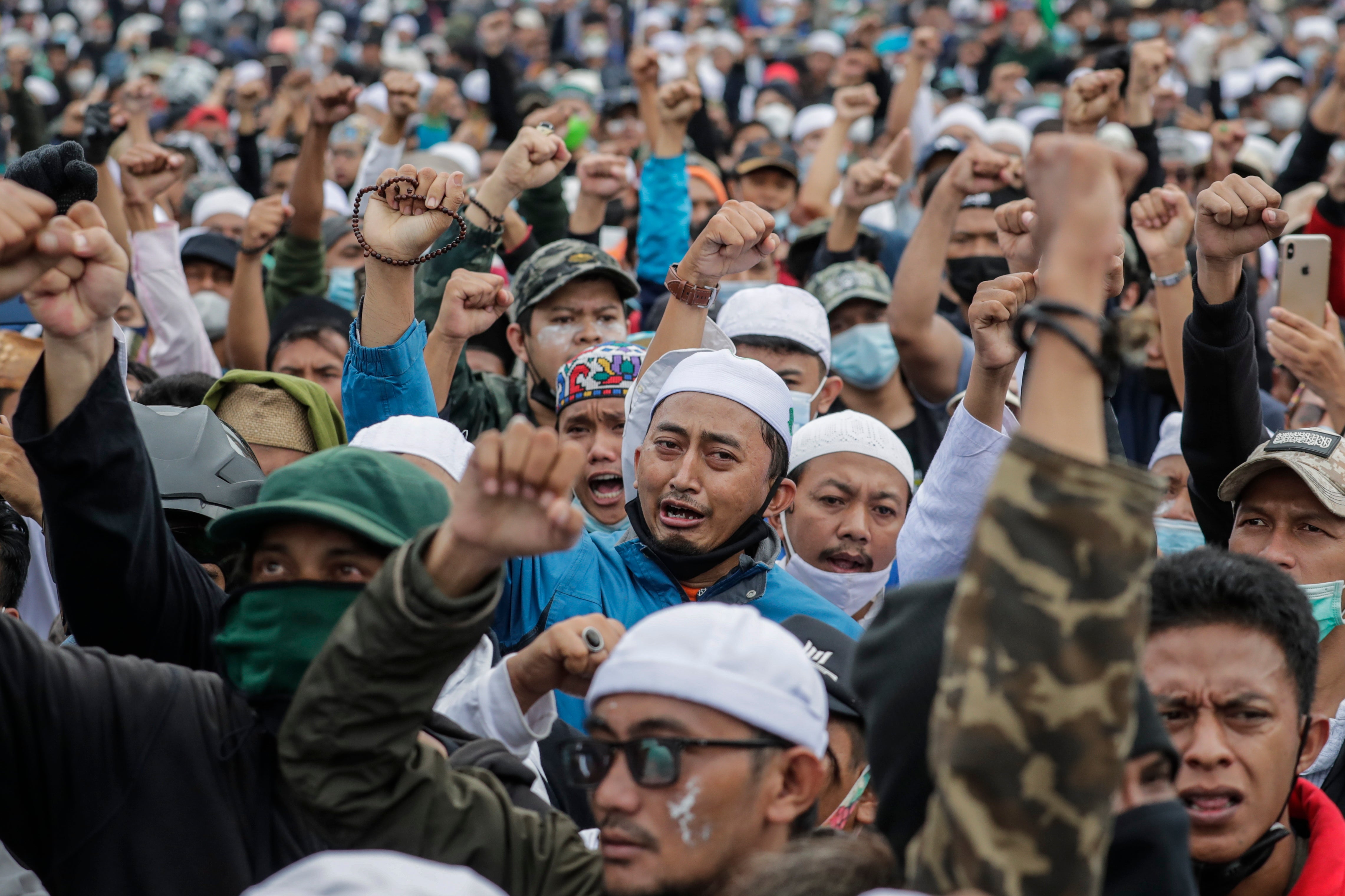 Supporters of Indonesian cleric Rizieq Shihab shout slogans during a protest near the East Jakarta district court on 24 June, 2021