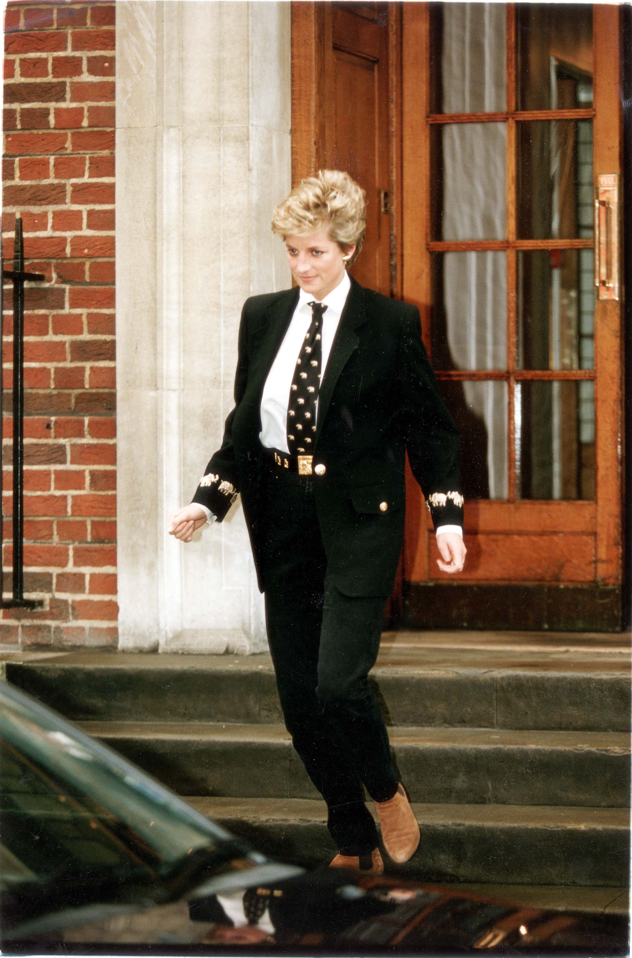 Diana became more experimental with her fashion looks in the 1990s, as this androgynous ensemble illustrates. This black suit comprised an oversized blazer with elephant embellishments on the sleeve. Diana wore also chose a gold statement belt with a large buckle and a tie with elephants on it, to match the sleeves.