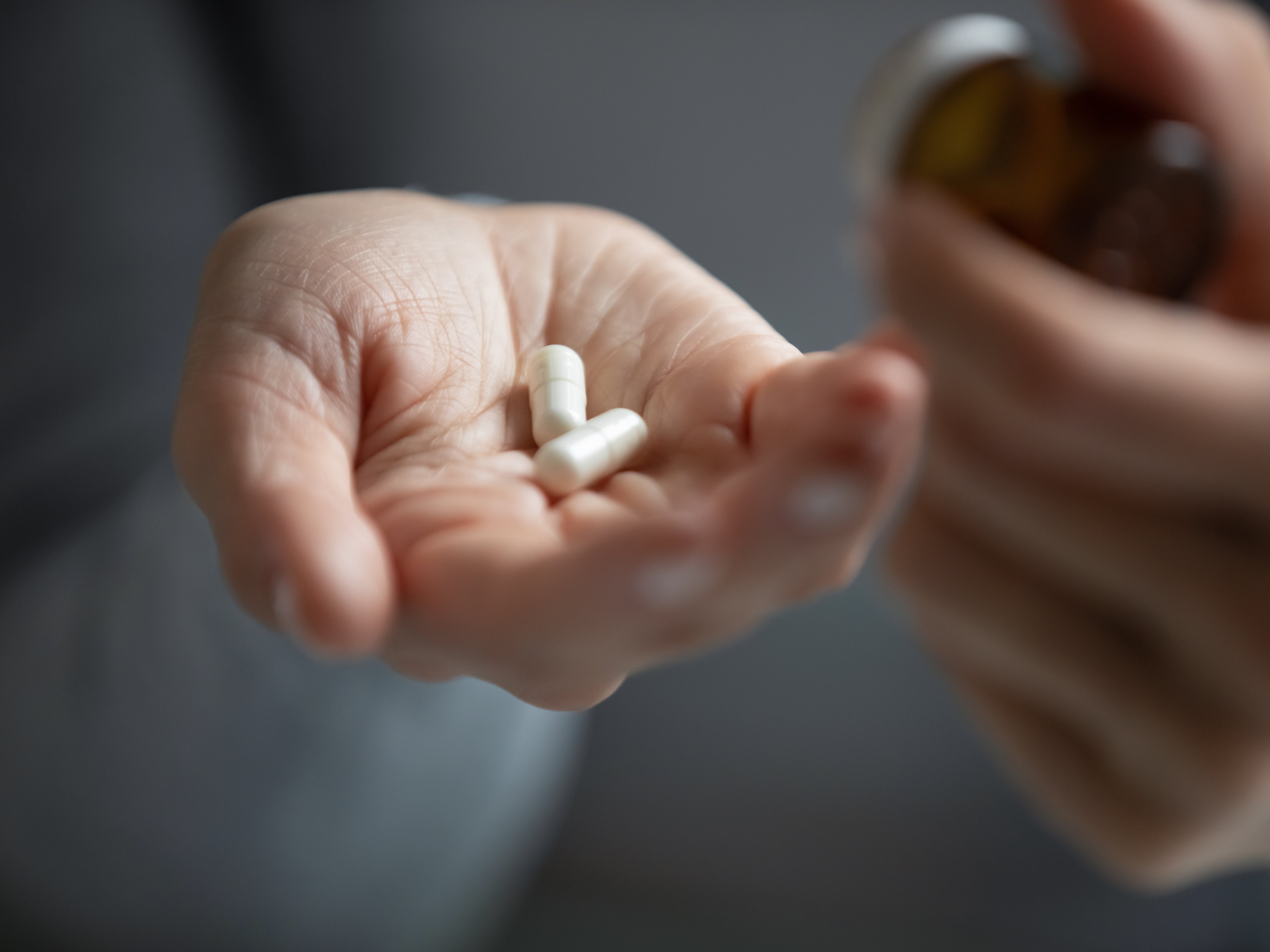 <p>A person holds antidepressants</p>