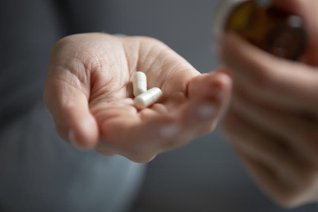 <p>A person holds antidepressants</p>