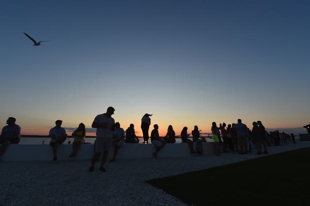 <p>Beachgoers enjoy the sunset in Newport, Rhode Island.</p>
