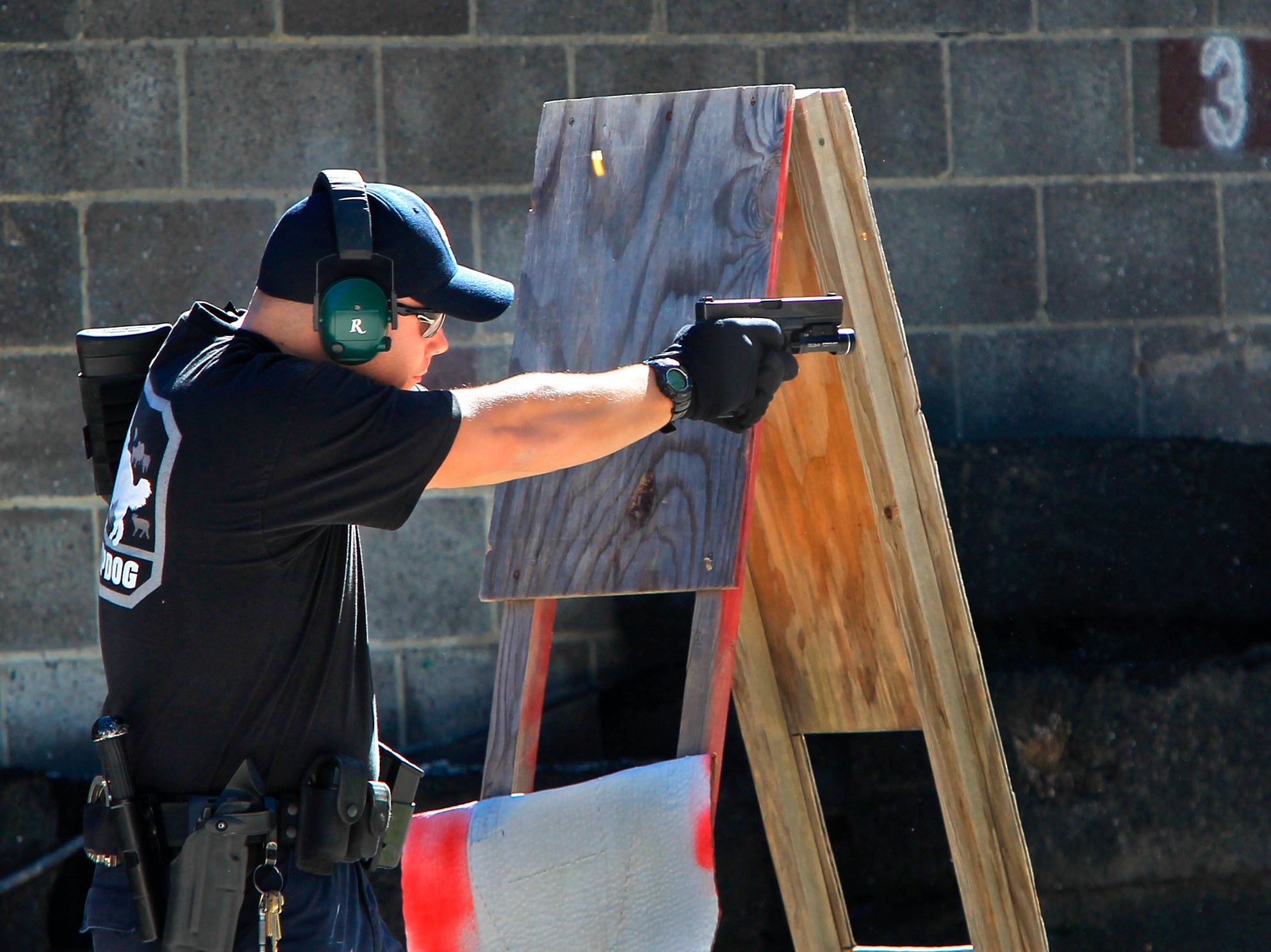 <p>A police officer shoots a pistol during a police training exercise at the Eagle Creek Firearms Training Facility in Findlay, Ohio</p>
