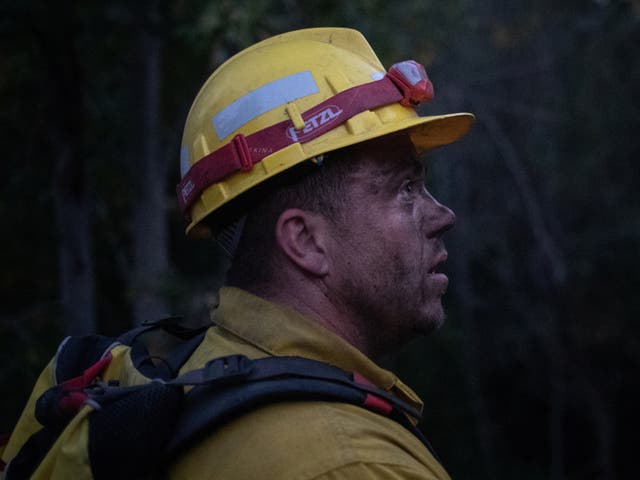<p>Douglas White, 28, an inmate from Warner Creek Correctional Facility, working as a firefighter, looks on as he is covered in dust and sweat, while helping to mop up hotspots from the Brattain Fire, near Paisley, Oregon, US, 19 September, 2020. REUTERS/Adrees Latif </p>