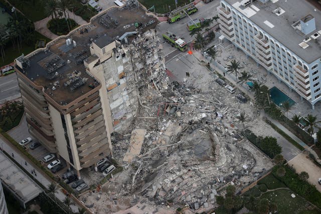 <p>Search and rescue personnel work in the rubble of the 12-story condo tower that crumbled to the ground after a partial collapse of the building on June 24, 2021 in Surfside, Florida.</p>
