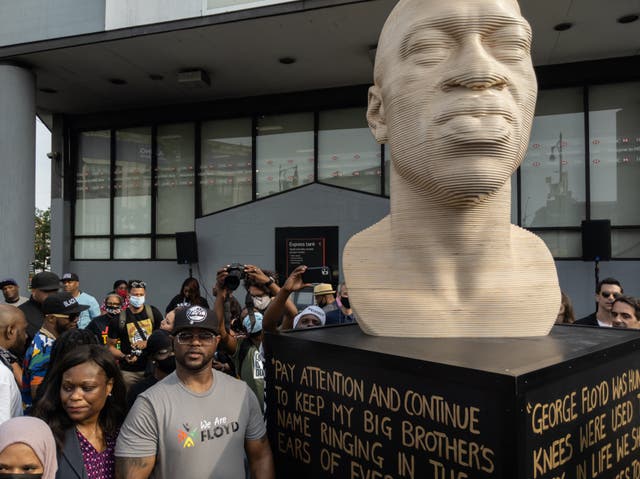 <p>Terrence Floyd (2nd L) stands with attendees at the unveiling of a statue of his brother George Floyd by artist Chris Carnabuci, as part of Juneteenth celebrations in Brooklyn, New York on June 19, 2021.</p>