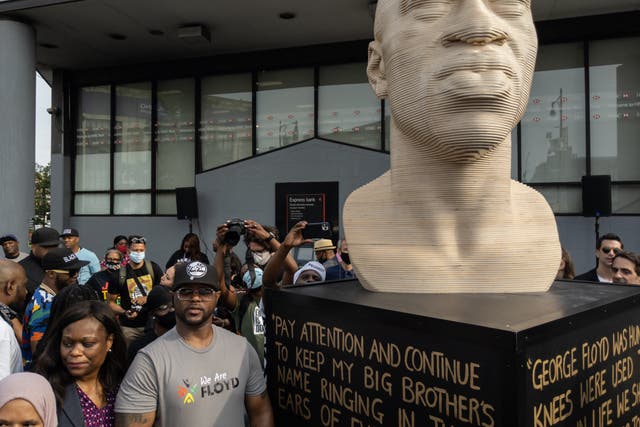 <p>Terrence Floyd (2nd L) stands with attendees at the unveiling of a statue of his brother George Floyd by artist Chris Carnabuci, as part of Juneteenth celebrations in Brooklyn, New York on June 19, 2021.</p>