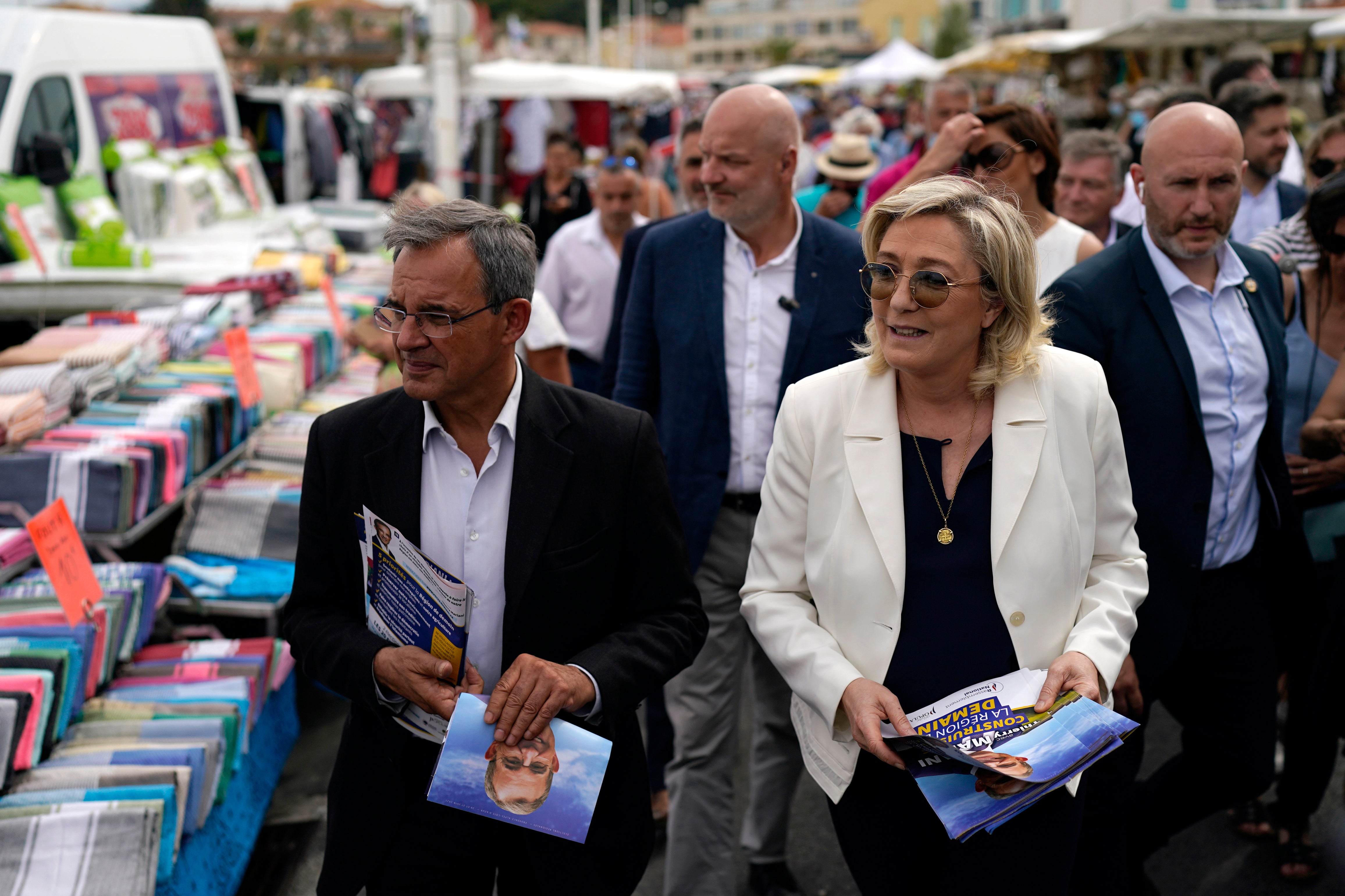 Far-right leader Marine le Pen, right, and local candidate Thierry Mariani, left, campaign in Six-Fours-les-Plages, southern France