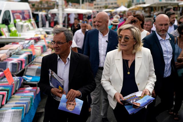 <p>Far-right leader Marine le Pen, right, and local candidate Thierry Mariani, left, campaign in Six-Fours-les-Plages, southern France</p>