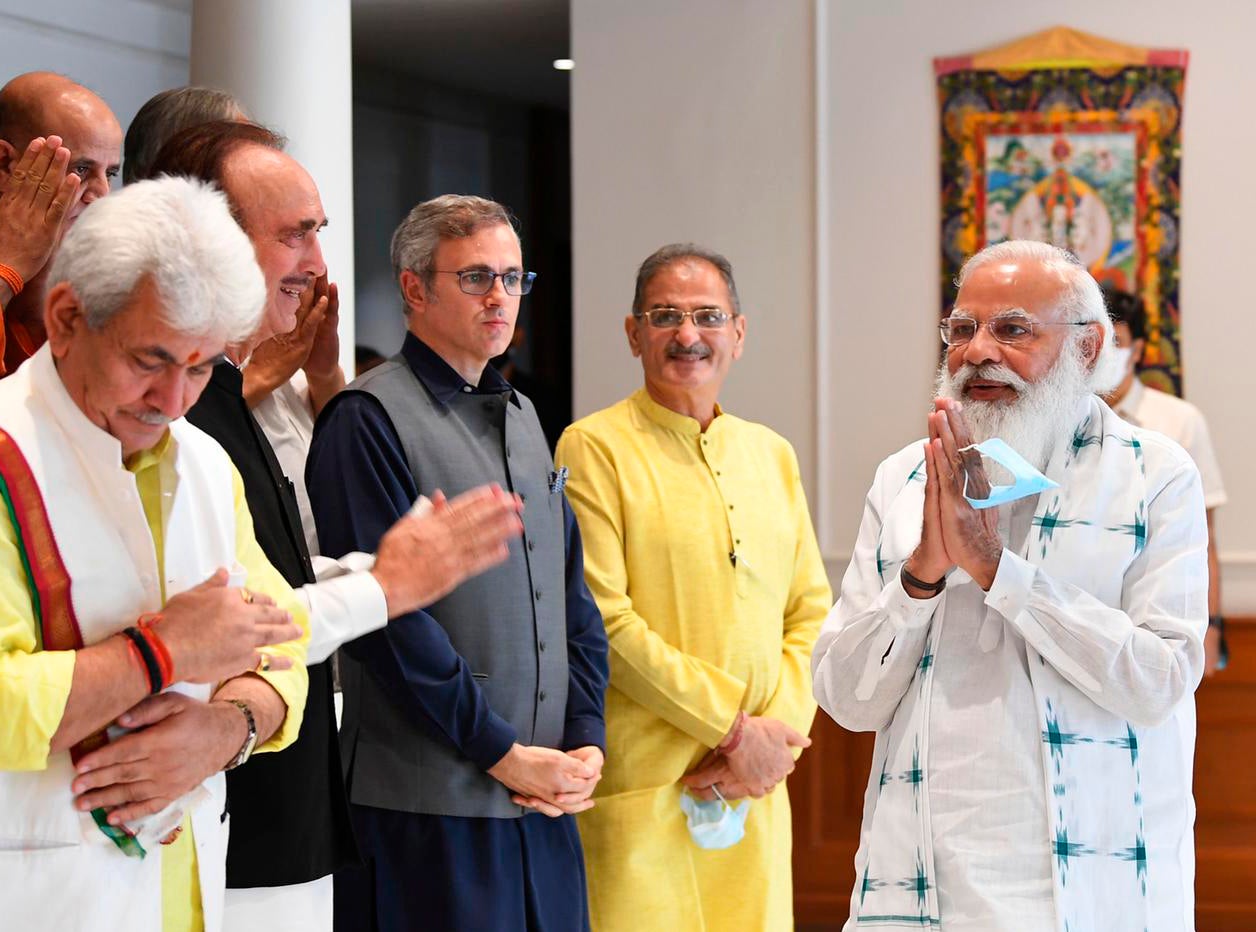 The photograph provided by the Prime Minister’s Office shows Indian PM Narendra Modi greeting members of various political parties before their meeting in New Delhi on 24 June, 2021