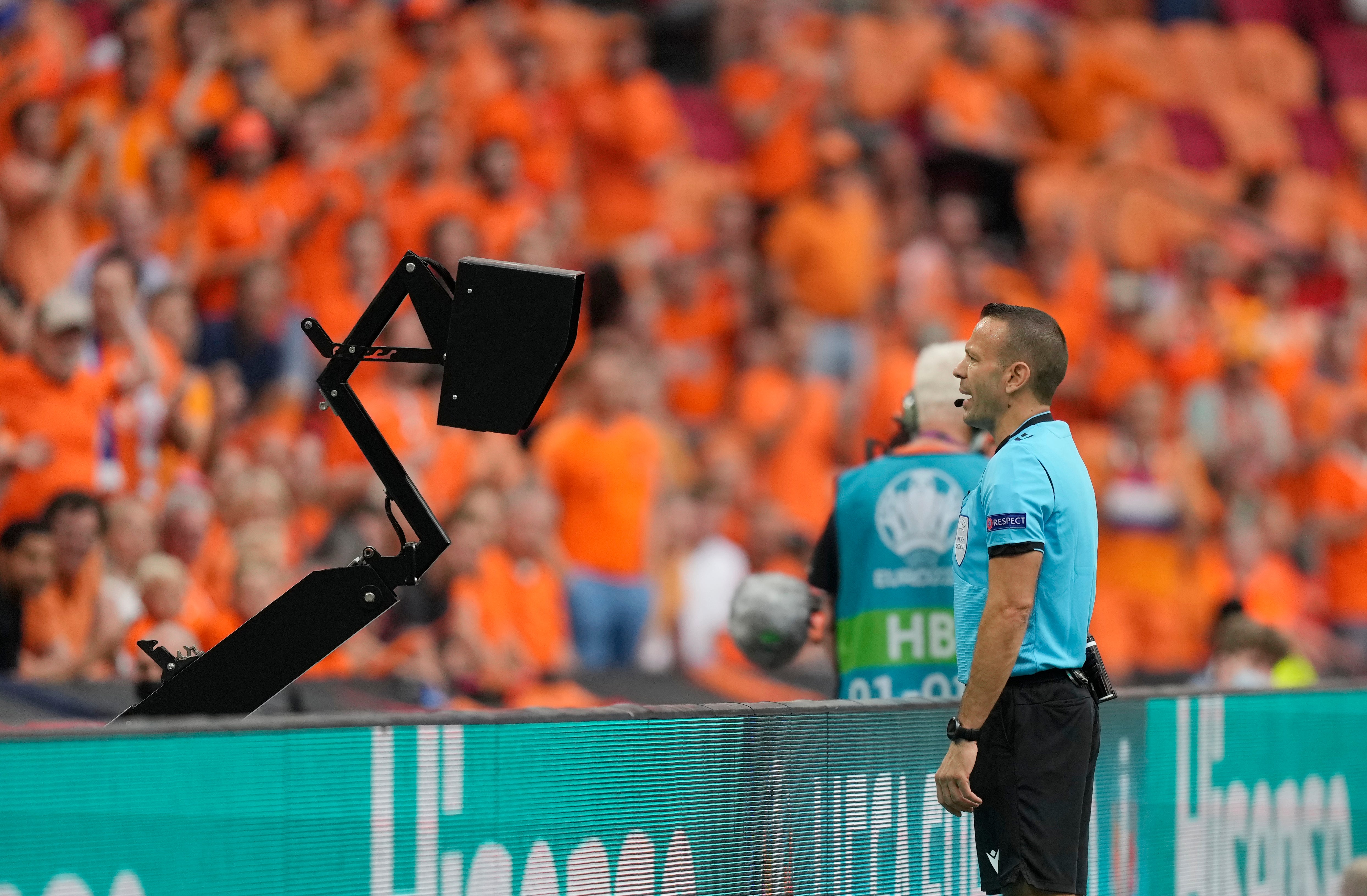 Israeli referee Orel Grinfeld checks the monitor and subsequently awards Holland a penalty against Austria