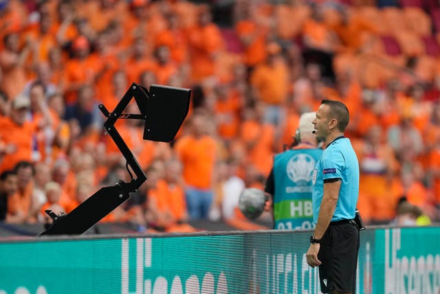 Israeli referee Orel Grinfeld checks the monitor and subsequently awards Holland a penalty against Austria