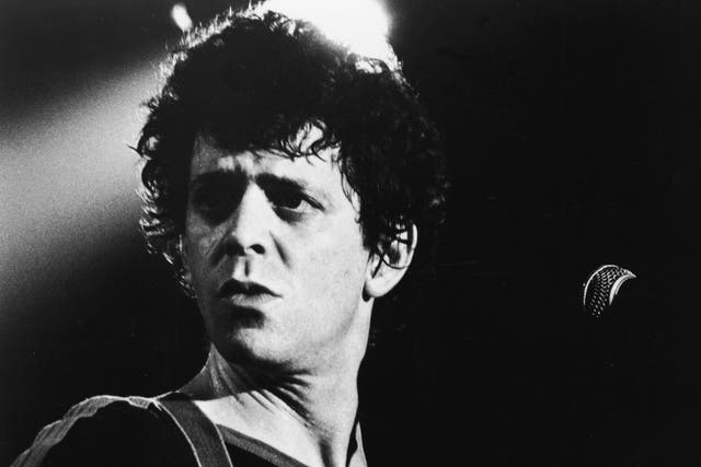 <p>Lou Reed on stage with a guitar, 1970s</p>