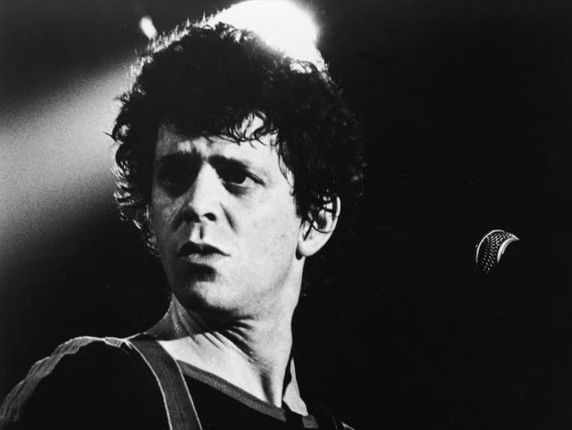 <p>Lou Reed on stage with a guitar, 1970s</p>