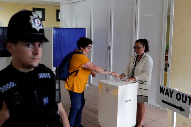 <p>A woman casts her vote during the abortion referendum at a polling station</p>