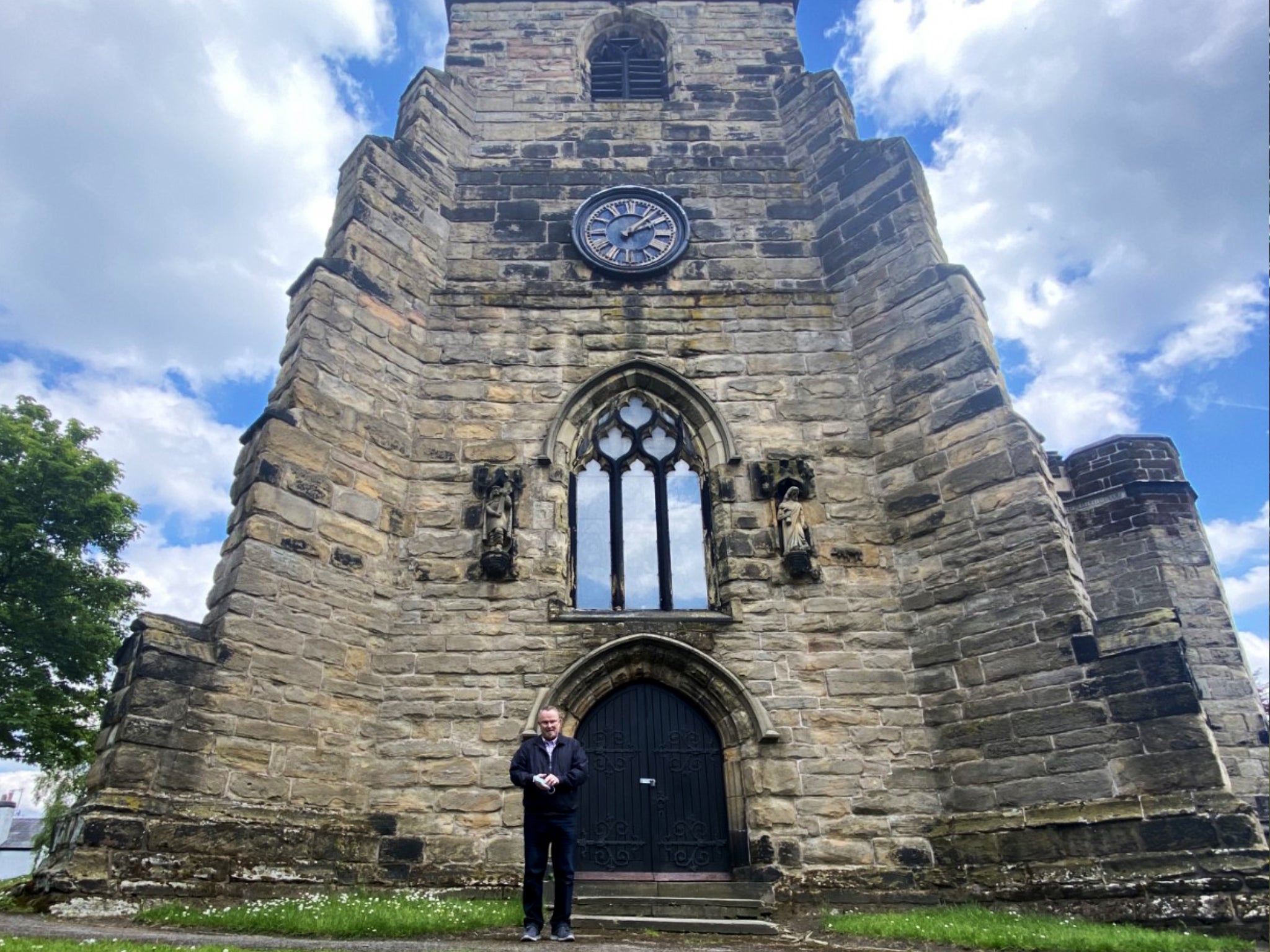 Church treasurer and local historian Peter Beck outside the church clock tower