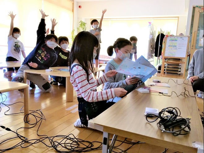 Children take a push-button quiz at the Poppins After-School care center of Nagoya University