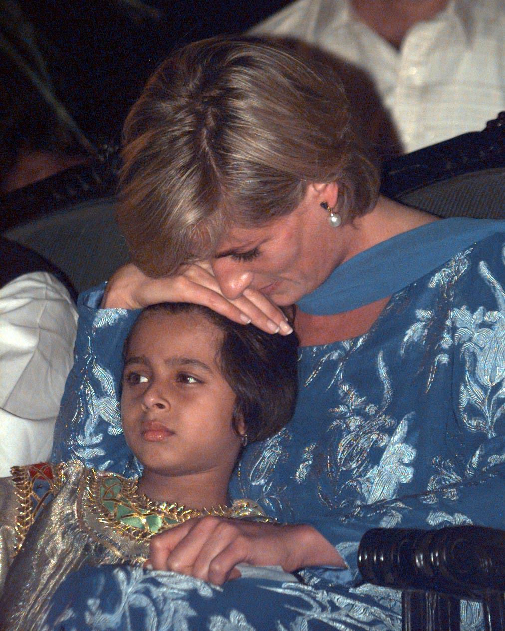 Princess Diana was pictured cuddling a young girl at Imran Khan’s Cancer Hospital.