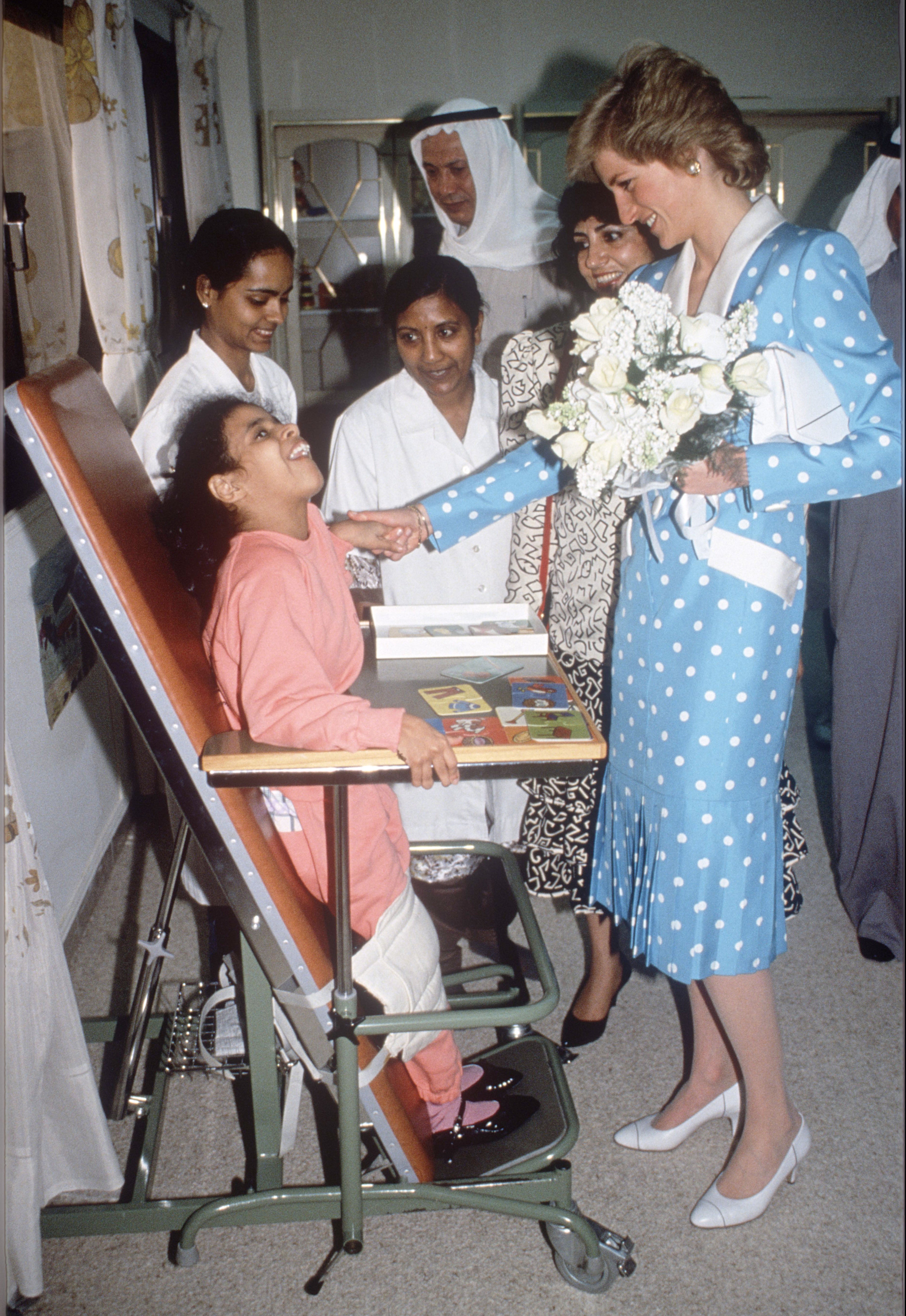 Princess Diana greeting a child with a disability during her royal tour of the Gulf States in March 1989.