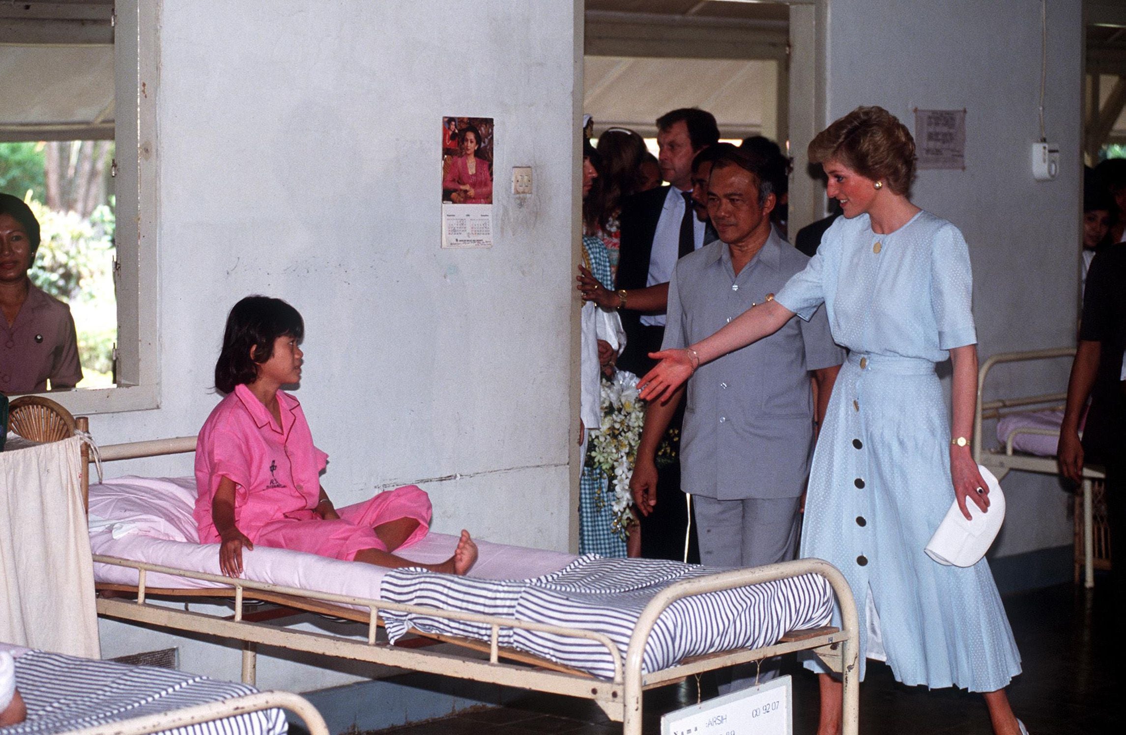 Princess Diana pictured greeting a child in a hospital during her tour of Indonesia with Prince Charles in 1989.