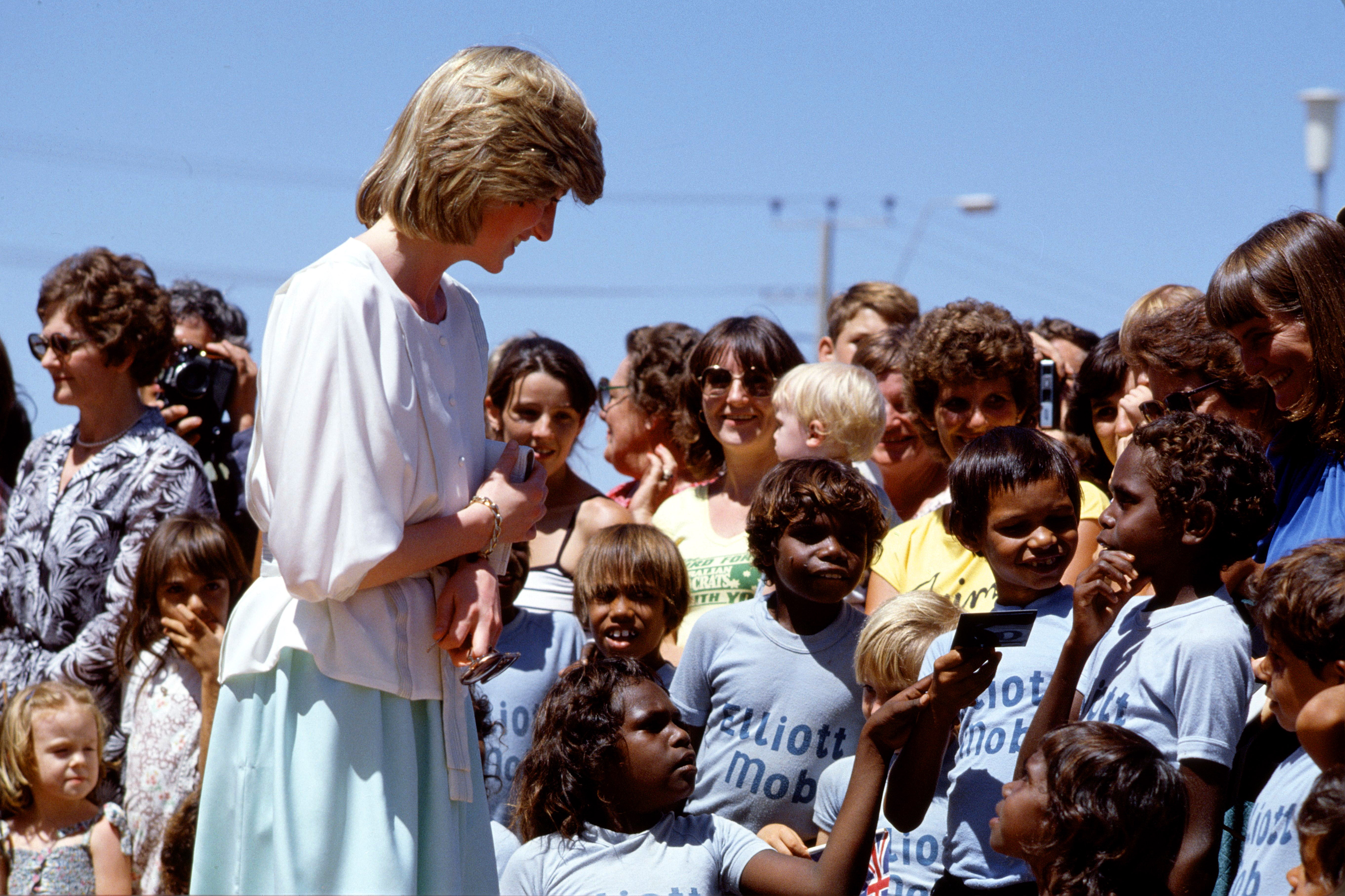 Princess Diana speaking to a group of children during her official tour of Australia with Prince Charles in 1983.